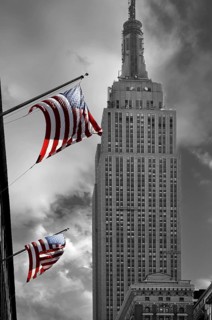 Waving US flag with Empire State Building, New York City, USA