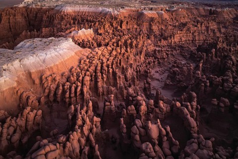 The ethereal view of Goblin Valley State Park in Utah, depicting the layered rock formations and