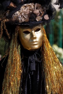 Venetian carnival mask and costumes at the Venetian fair on the historic market square,