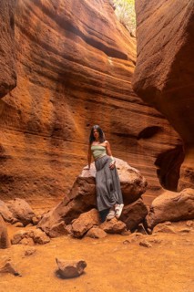 Woman standing in the magnificent barranco de las vacas canyon in gran canaria, admiring the unique