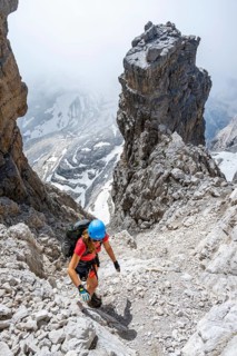 Female hiker climbs the Cima falconer mountain peak, Brenta Mountains, Brenta, Brenta-Adamello