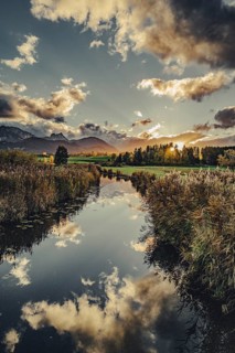 Lake Hopfensee in the Allgäu in autumn with warm sunset light against a picturesque Alpine