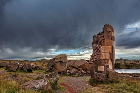 Stone structure and rocks under an impressive sky, The Chullpas of Sillustani near Puno in Peru