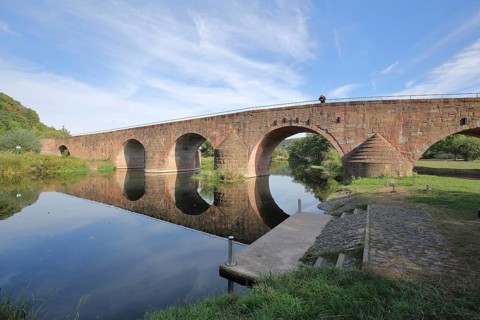 Bridge of Unity, medieval stone arch bridge with reflection in the Werra, Werra Bridge, Vacha,