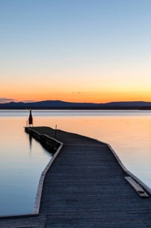 Long boat dock at dusk on Lake Siljan near Nusnäs, Dalarnas län, Sweden