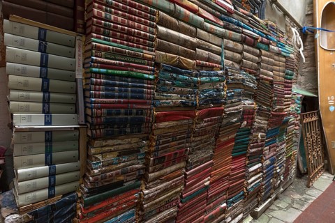 Stacked books on a wall after flood damage in a bookstore, Venice, Veneto, Italy