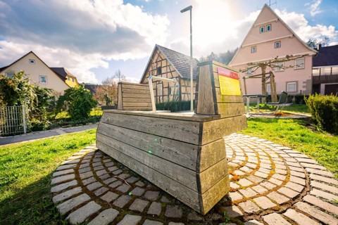 Rowing machine is located in a small village in the sun, surrounded by traditional houses,