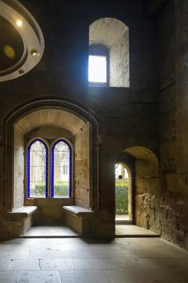 Sunlight illuminating interior of the palace of the kings of navarre through blue stained glass