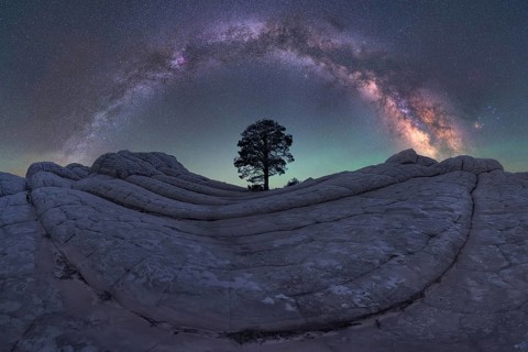 A breathtaking nightscape of the Milky Way galaxy soaring over the unique rock formations of White