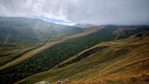 Misty mountain landscape with rolling hills and cloudy sky, Stepantsminda, Caucasus, Georgia