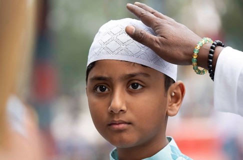 Muslim child arrives to Eid al-Fitr prayer at Eidgah, on March 21, 2026 in Guwahati, India. Muslims