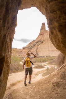 Vertical photo of a man walking for a path in the desert