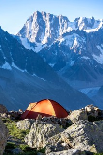Red tent in front of a mountain panorama, mountain landscape in the morning light, mountain peak