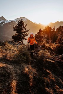 Hiker in the Allgäu at sunset in spring on the Zirmgrat near Pronten in the Allgäu
