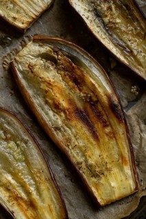 Close-up of oven-baked eggplant slices, showcasing their rustic texture and golden-brown finish.