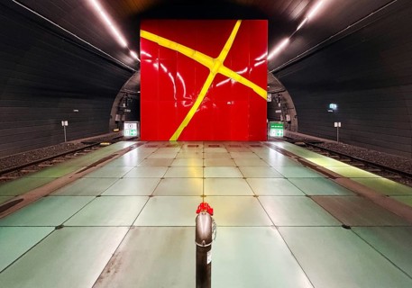 Lohring subway station with red enamelled wall with a painted light cross by Eva-Maria Jöressen,