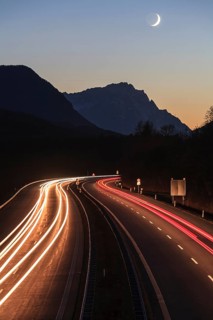 Night shot of a motorway, long exposure, moon, twilight, traffic, car lights, A 95, behind it