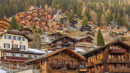 Old farmhouses in the historic town center, modern chalets built back into the hillside, Grimentz,