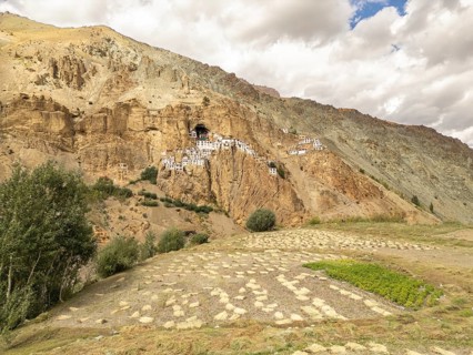 Phugtal Monastery clings to a rugged cliff in the serene Lungnak Valley of Zanskar, Ladakh. This