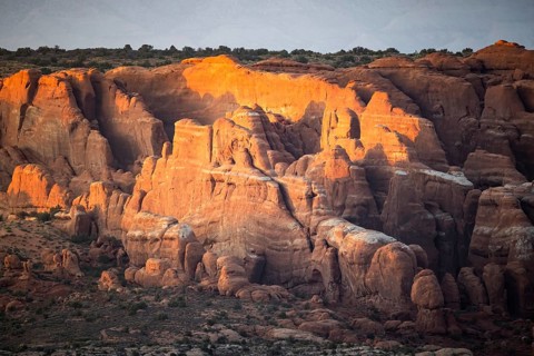 Captivating view of Arches national park' rock formations bathed in warm sunset light. The natural
