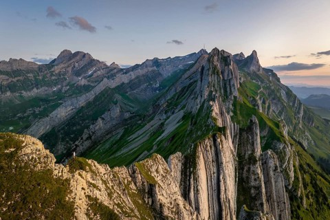 A breathtaking panoramic view of the Altenalp Turm in Switzerland during sunset. The rugged peaks