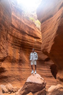 Tourist standing on a rock, admiring the breathtaking view of barranco de las vacas canyon in gran