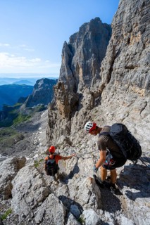 Two mountaineers on the Via Ferrata Bocciere Centrale via ferrata, spectacular mountain landscape