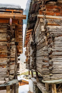 Old, weathered barn on stone slabs, historic town center, Grimentz, Val d'Anniviers, Valais Alps,
