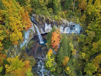 Aerial view of Berglistüber waterfall in autumn-colored surroundings, Linthal, Klausenpass, Canton