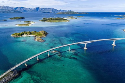 Sommaroy Bridge connecting Kvaloya Island to Sommaroy Island, small islands, mountain range in the
