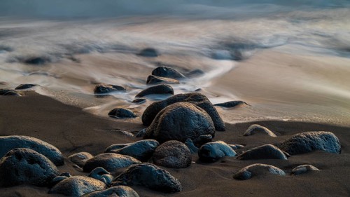Sunset, waves and rocks in the sea, Praia Formosa, Madeira, Portugal