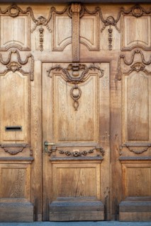 Beautifully decorated, historic wooden door at Falkensteiner Hof in the old town of Basel, Canton