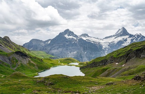 Mountain landscape with Bachalpsee mountain lake, Mittelhorn peaks and Schreckhorn with upper