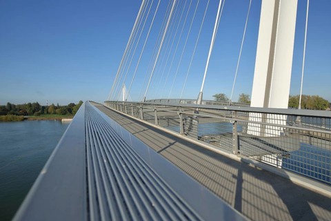 Modern cable-stayed bridge Passerelle des Deux Rives across the Rhine, footbridge with white