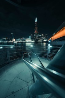 Nocturnal river landscape with illuminated building and bridge view, New Year's Eve London, Great