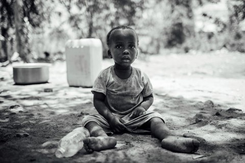 MICHAMVI KAE, ZANZIBAR - OCTOBER 17, 2025: A monochrome portrait of a young child sitting on the