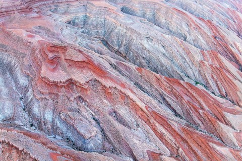 Striking aerial view featuring the vivid, layered rock formations of a canyon near the San Juan