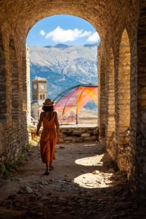 A woman walking in the arches of the fortress of the Ottoman castle of Gjirokaster or Gjirokastra