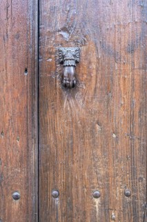 Hand as a door knocker on an old front door, Prizren, Kosovo, Balkans