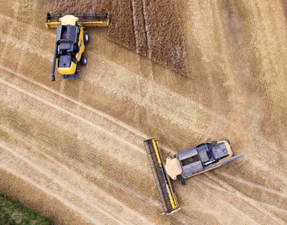 Grimma, 18.07.13 Harvesters harvesting in a field near Grimma. The picture was taken with a