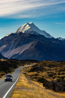 Stunning views of Mount Cook in autumn, showcasing the majestic snow capped peak and rolling hills.