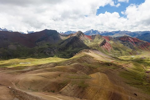 Panoramic view capturing the vibrant and varied hues of the mountainous terrain in the highlands of