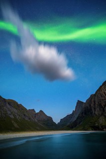 Northern lights at Horseid beach, sandy beach with mountains, Lofoten, Norway