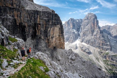 Three mountaineers on a hiking trail, rocky mountain landscape, Via Ferrata SOSAT via ferrata,