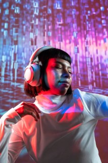 A futuristic Latin woman enjoys music through headphones, surrounded by vibrant, colorful lights