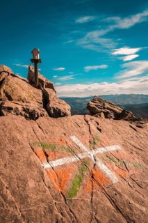 The flag of the Basque country and a figure of a house above Mount Adarra in Guipuzcoa one winter