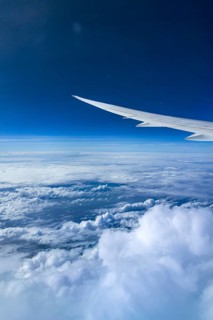 View from the aircraft window during a flight over India with the airline Etihad. Blue sky and
