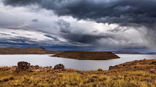 A lake with an island in cloudy sky, atmospheric landscape, The Chullpas of Sillustani near Puno in