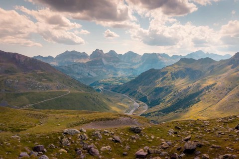 A breathtaking view of a serene mountain landscape with winding rivers and lush green valleys in