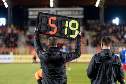 Team manager shows players substitution during football match at stadium in Glogow, Poland